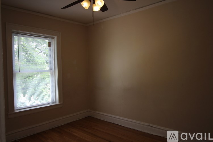 A room with a window and a ceiling fan.