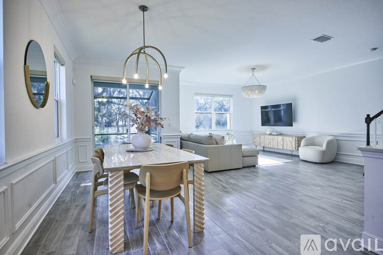 A modern dining room with a wooden table and chairs.