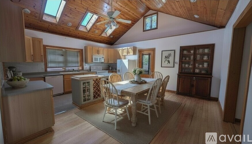 A kitchen with wooden cabinets and a white refrigerator.