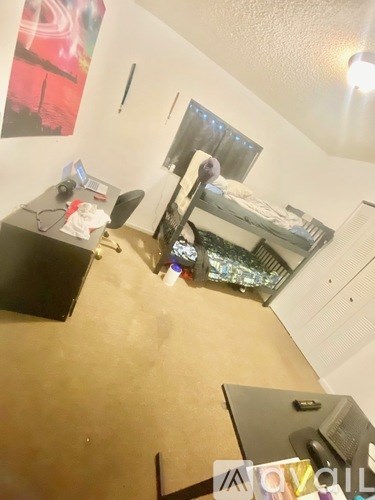 A room with a computer desk and a chair.