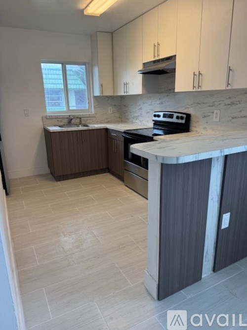 A room with a bunk bed and a desk.