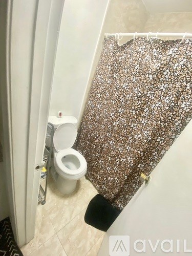 A toilet with a brown glittery cover.