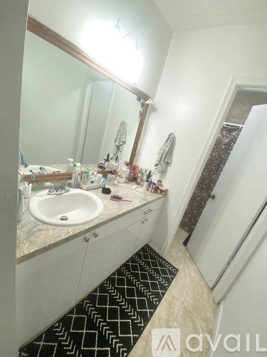 A bathroom with a sink and mirror.