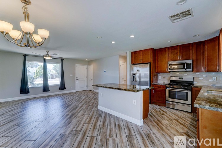 A spacious kitchen with wooden cabinets and a central island.