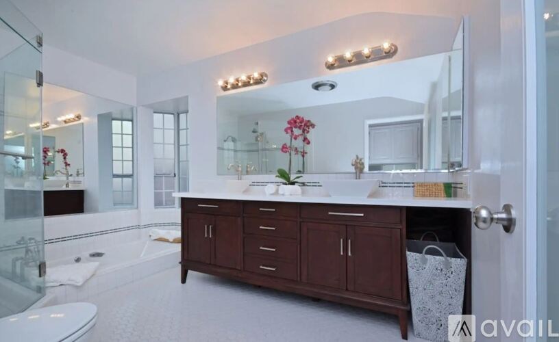 A bathroom with a vanity, a toilet, and a shower.