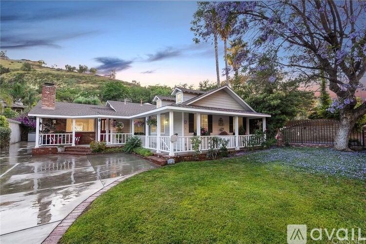 A house with a front porch and a lawn.