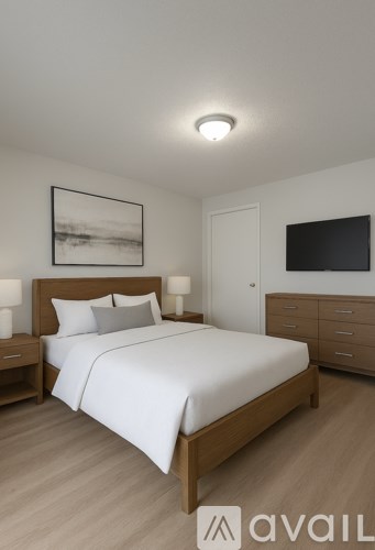 A bedroom with a large bed, a nightstand, and a painting on the wall.