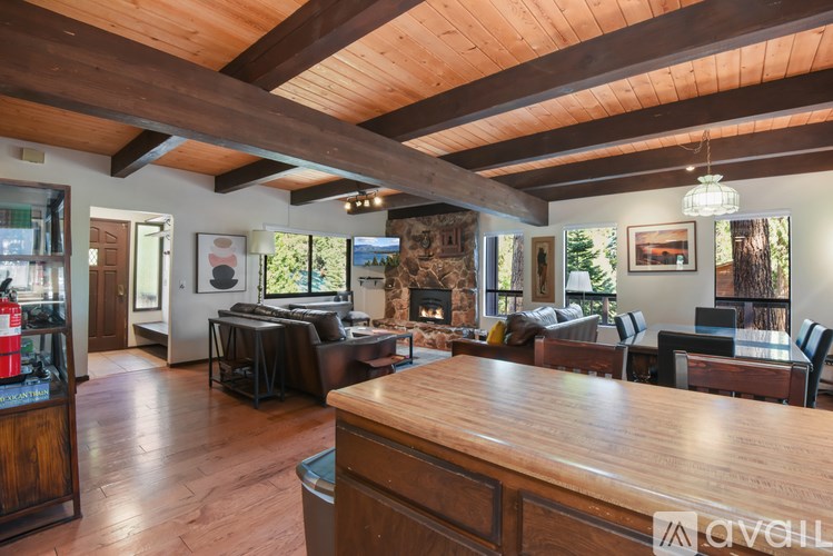 A modern kitchen with wooden floors and a large island.
