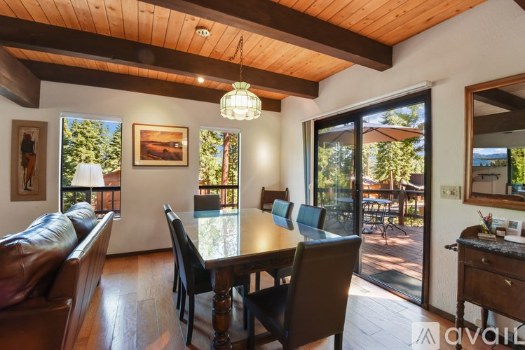 A dining room with a wooden table and chairs.