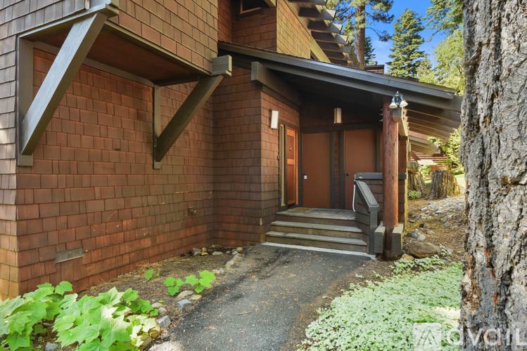 A house with a brown brick exterior and a wooden door.