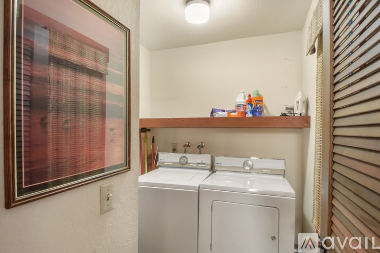 A small laundry room with a washer and dryer.
