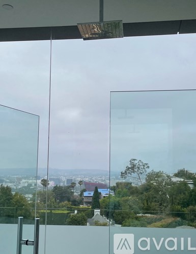 A view of a cityscape through a window with a glass door.