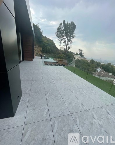 A modern building with a glass facade and a tiled roof.