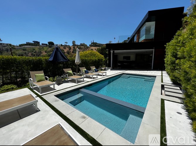 A modern house with a pool in the backyard.