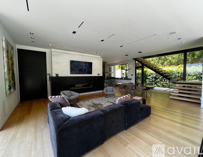 A modern living room with a large couch and a television.