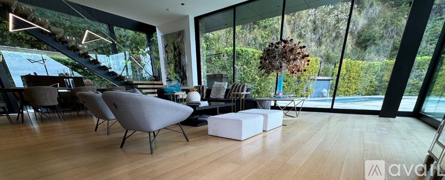 A modern living room with a grey sofa and a wooden floor.
