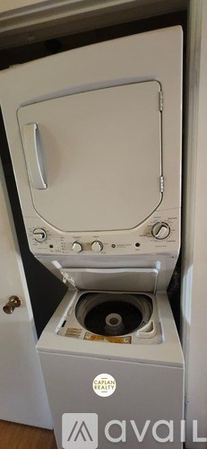 A white microwave oven with a silver handle and control panel.