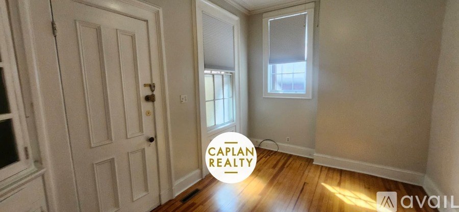 A hallway with a door and a window.