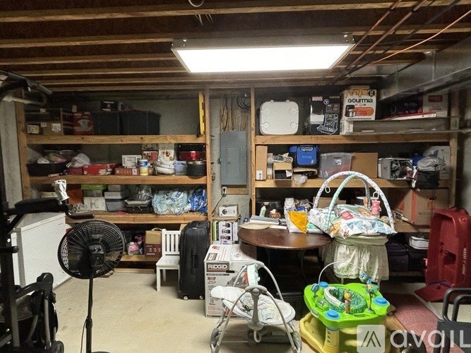 A room with a fan and a table with a basket on it.