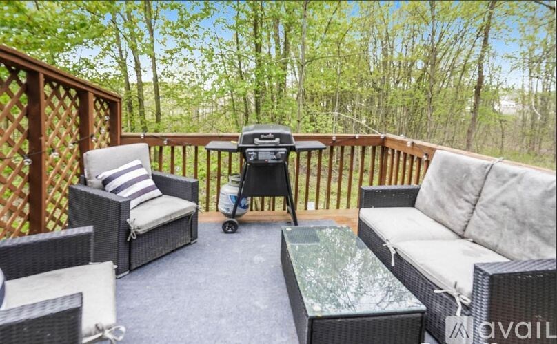 A patio with a table, chairs, and a stroller.