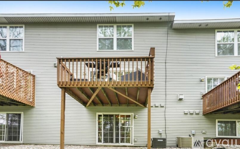 A balcony with a railing and a dog on it.