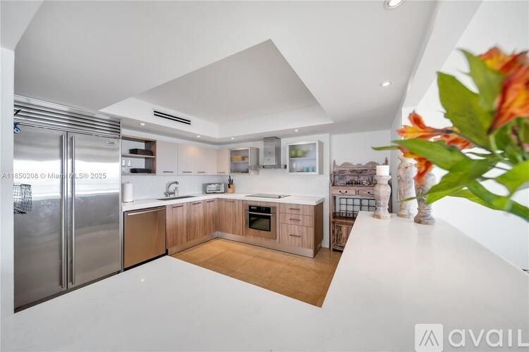 A modern kitchen with wooden cabinets and stainless steel appliances.