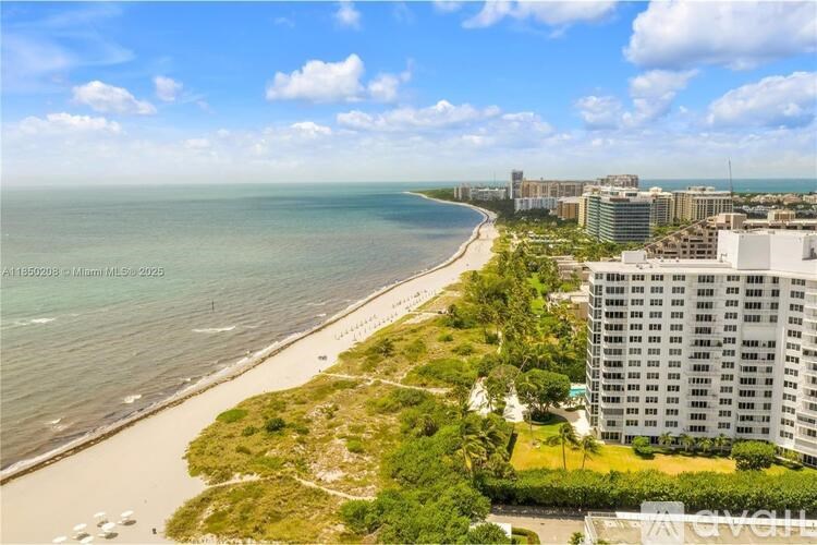 A beachfront view with a building on the right side.