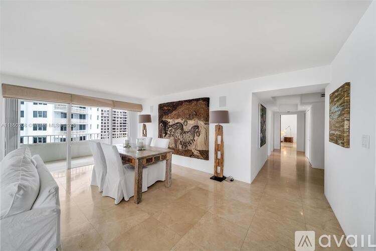 A living room with a dining table and chairs, a couch, and a large painting on the wall.
