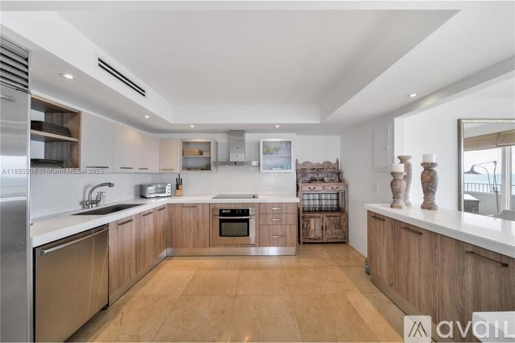 A modern kitchen with wooden cabinets and stainless steel appliances.