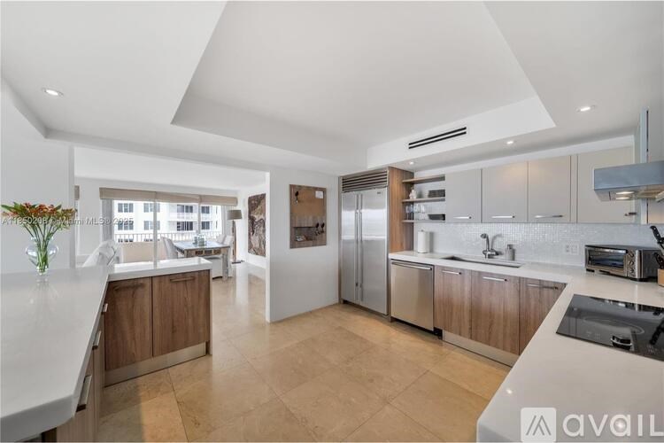 A modern kitchen with wooden cabinets and a large island.