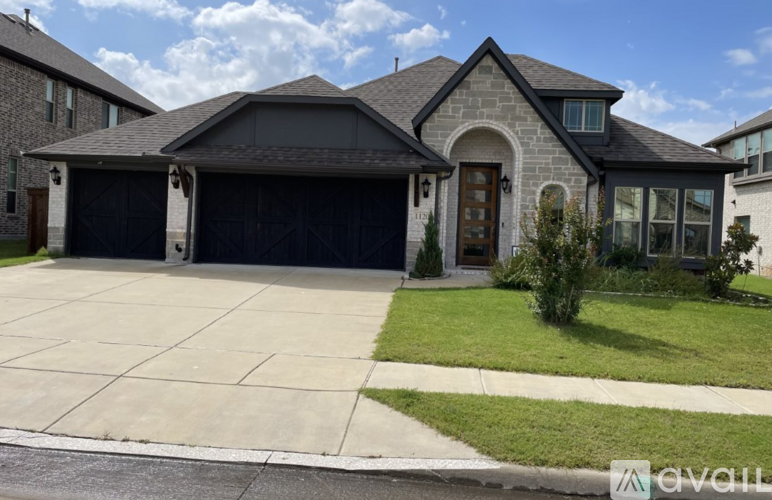 A house with a garage and a driveway in front.