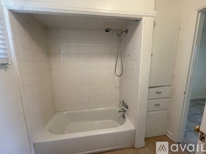 A white bathroom with a tub and a shower.