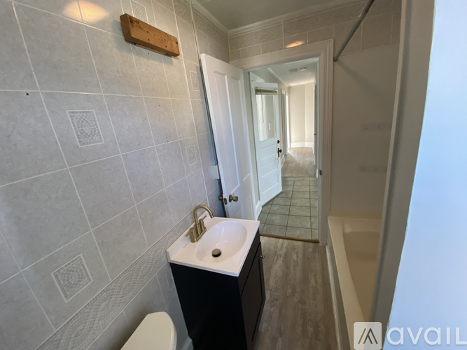 A room with a window and a door is available for rent.