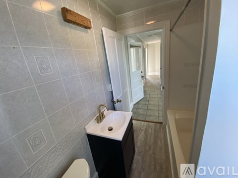 A room with a window and a door is available for rent.