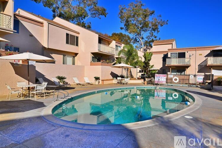 A pool in a courtyard surrounded by buildings.