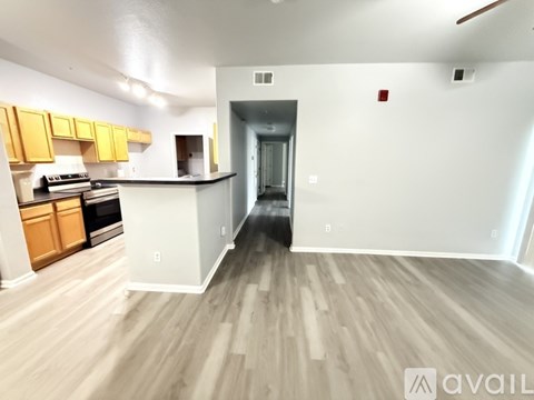 A kitchen with wooden floors and white walls.