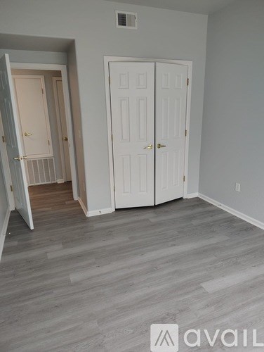 A room with a white door and a white cabinet.