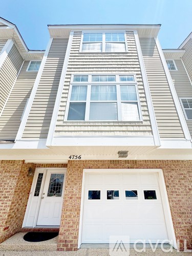 A two-story building with a white garage door.