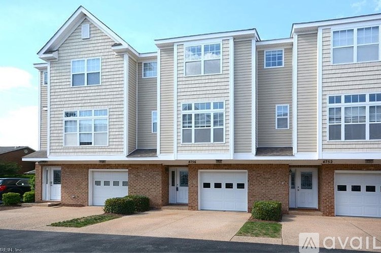 A row of townhouses with garages are for sale.