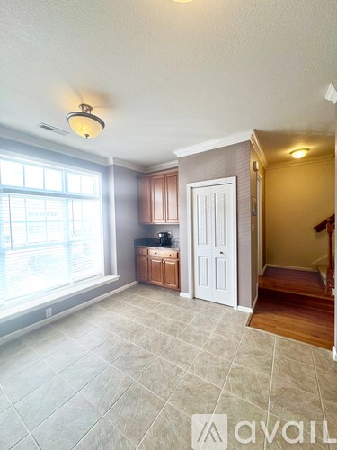 A living room with a kitchen area in the background.