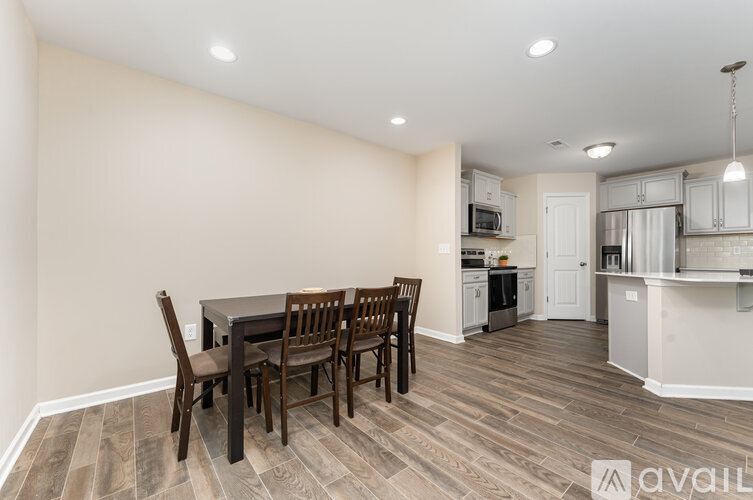 A kitchen with a dining table and chairs.