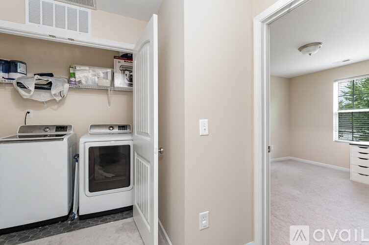 A kitchen with a white oven and a white fridge with a white microwave above it.
