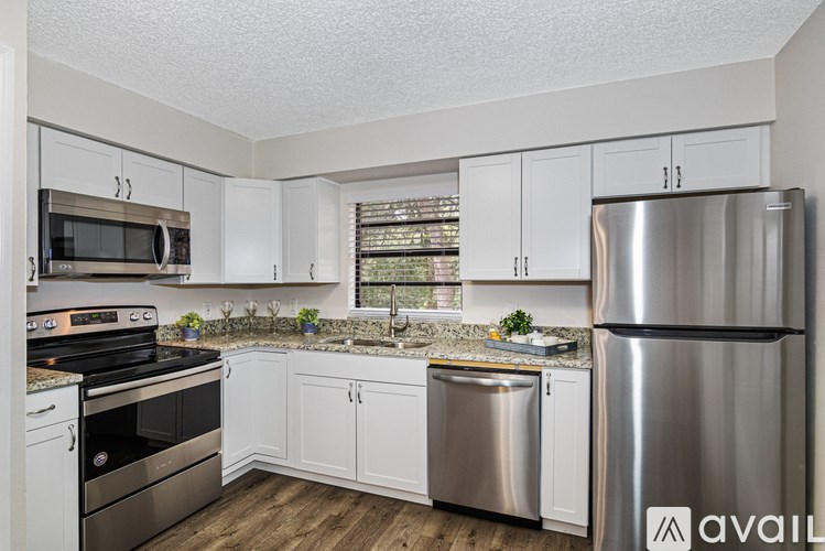 A kitchen with white cabinets and stainless steel appliances.