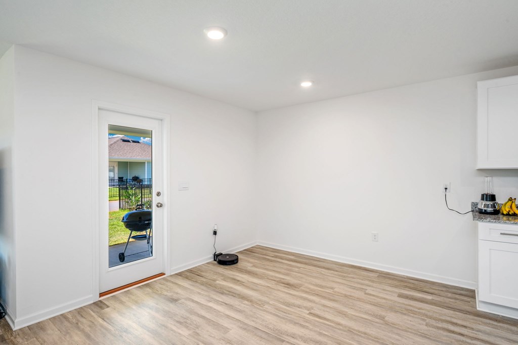 A room with a white door and a white cabinet.