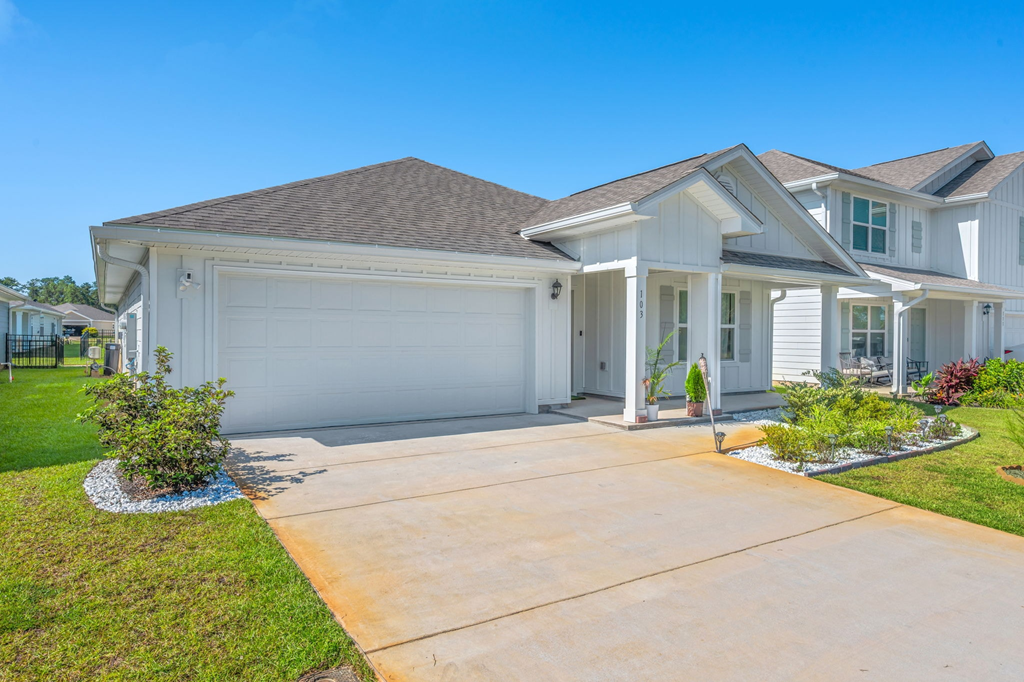 A large, well-maintained house with a driveway and landscaping.