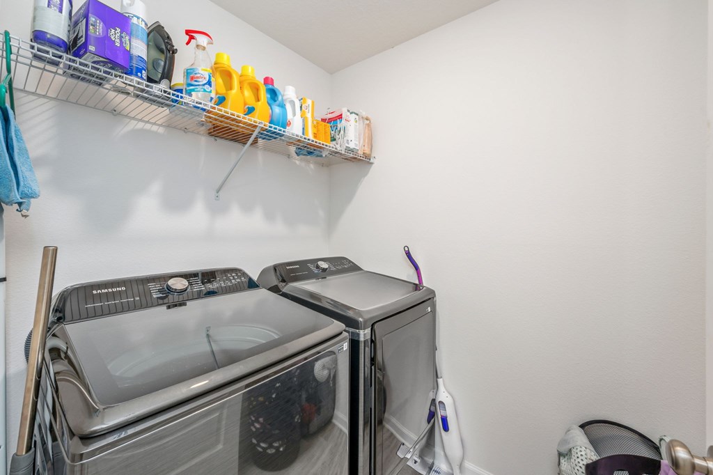 A small laundry room with a washer and dryer.