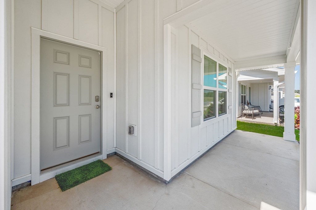 A white door is on the left and a white wall is on the right.