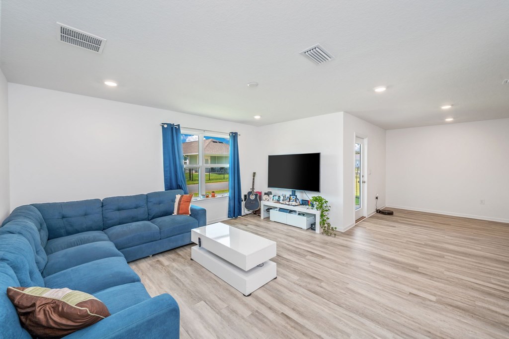 A living room with a blue sofa and a white coffee table.