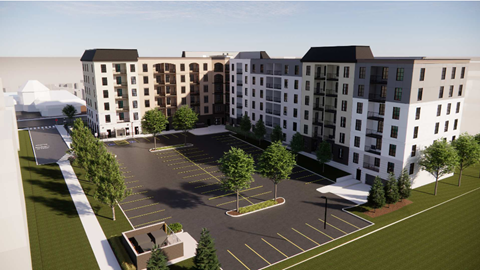 A large white building with a parking lot in front.