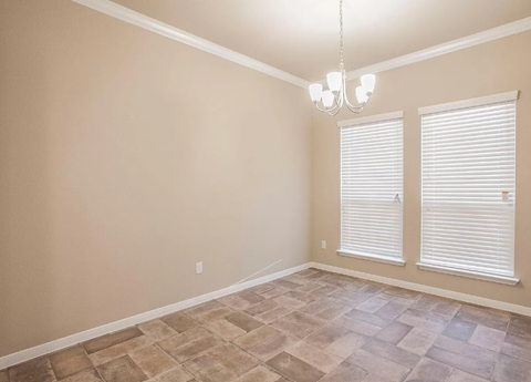 A room with a tiled floor and a chandelier.
